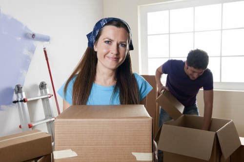 Professional movers packing household items for a Chessington move